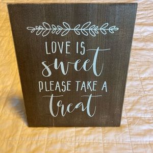 “LOVE IS SWEET PLEASE TAKE A SWEET” sign